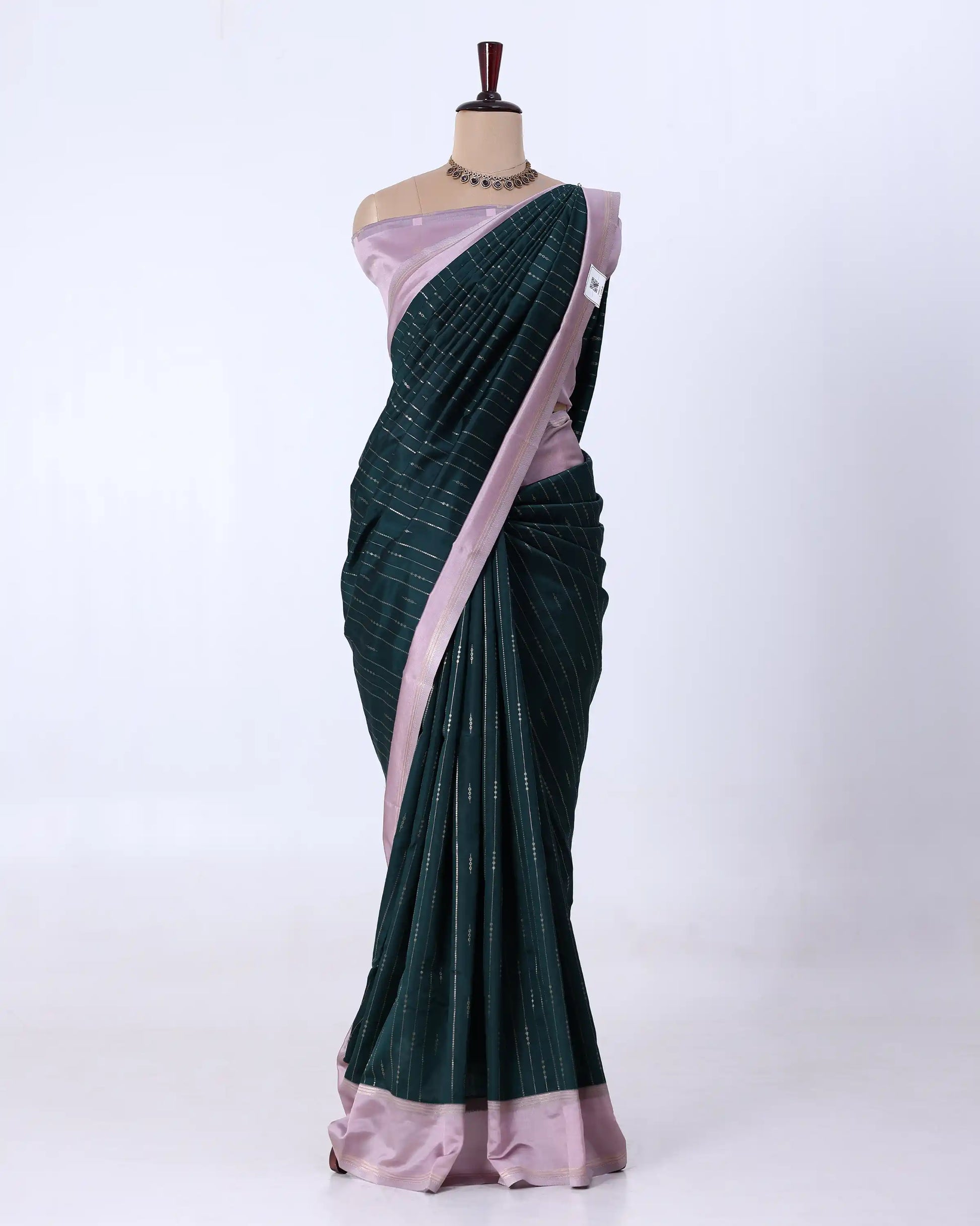 A dark green and light pink saree 