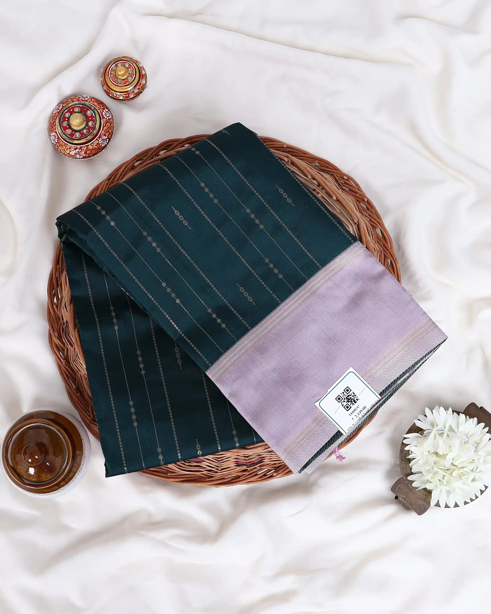 A folded dark green and lavender saree 