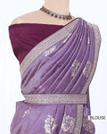 A lavender purple saree with silver floral zari embroidery, paired with a deep purple off-the-shoulder blouse. 
