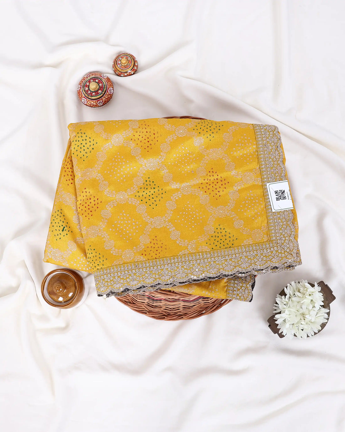 A yellow saree with gold zari embroidery and a matching waist belt