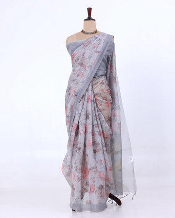 A light gray saree with a pink and green floral print