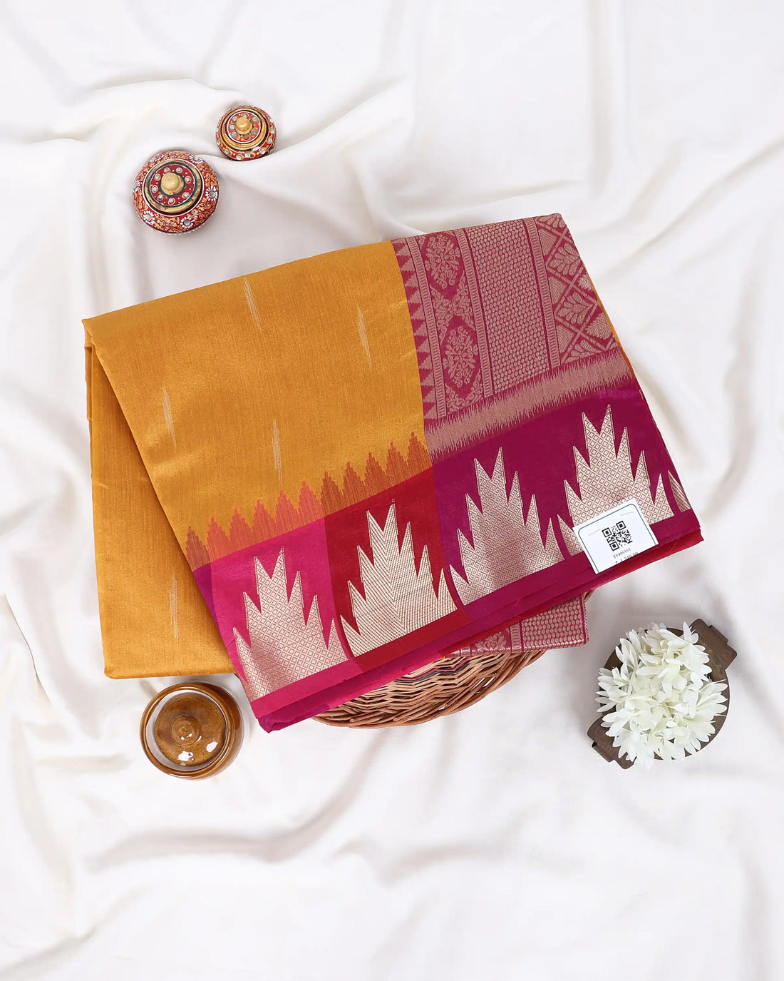 A yellow and magenta saree features a yellow body with a magenta border and a matching magenta pallu.