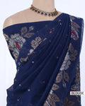 A navy blue saree with beige and red floral prints