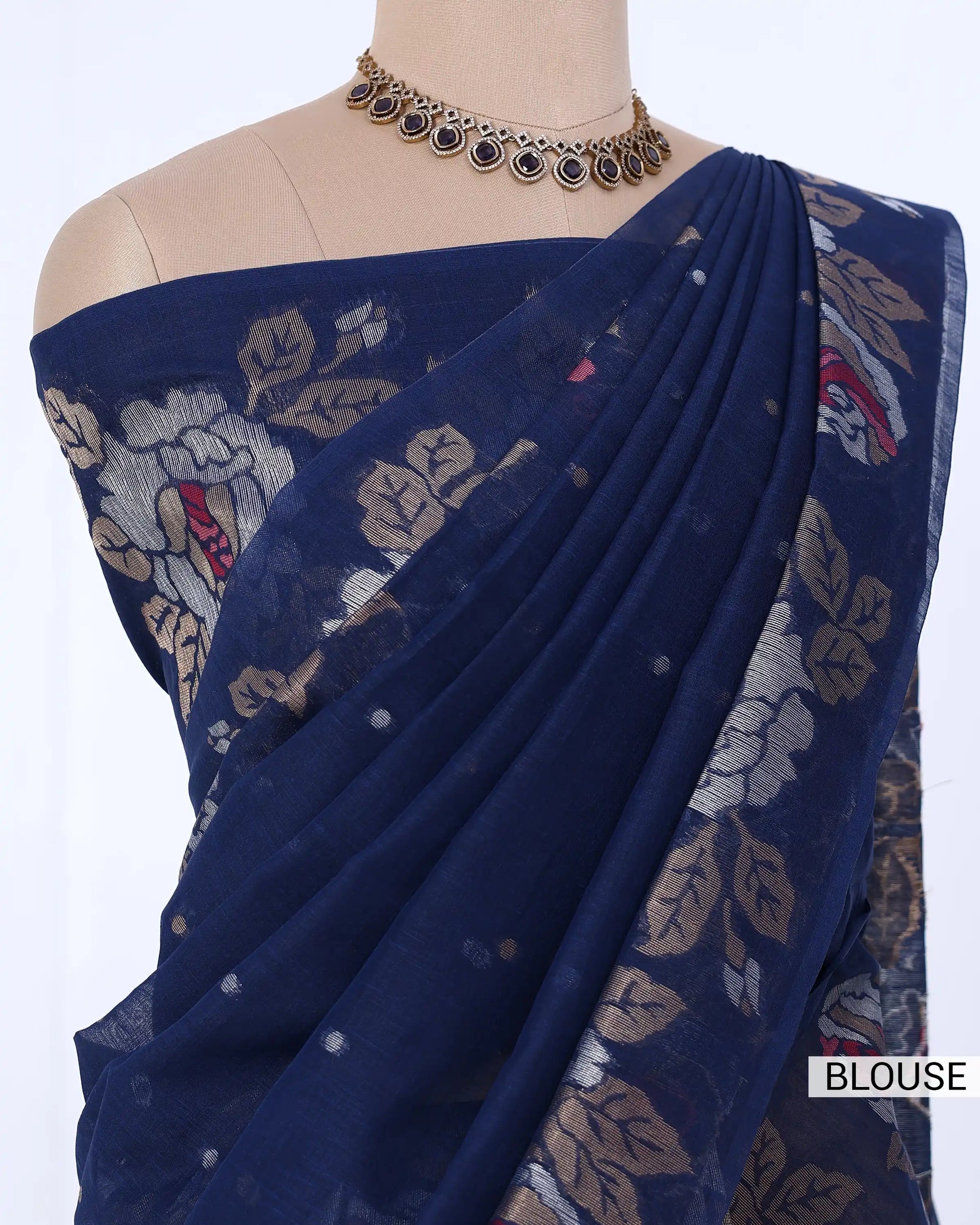 A navy blue saree with beige and red floral prints