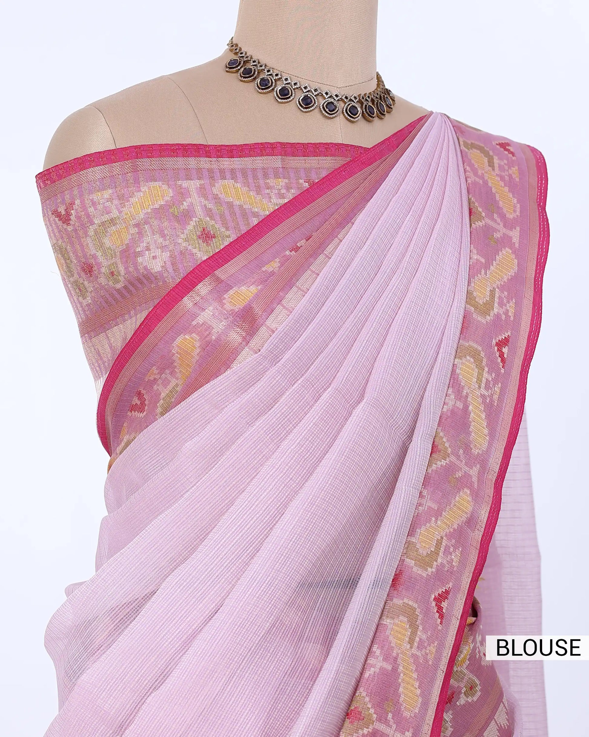 A light pink saree  featuring a matching pink blouse with yellow and white woven patterns and a pink border. 