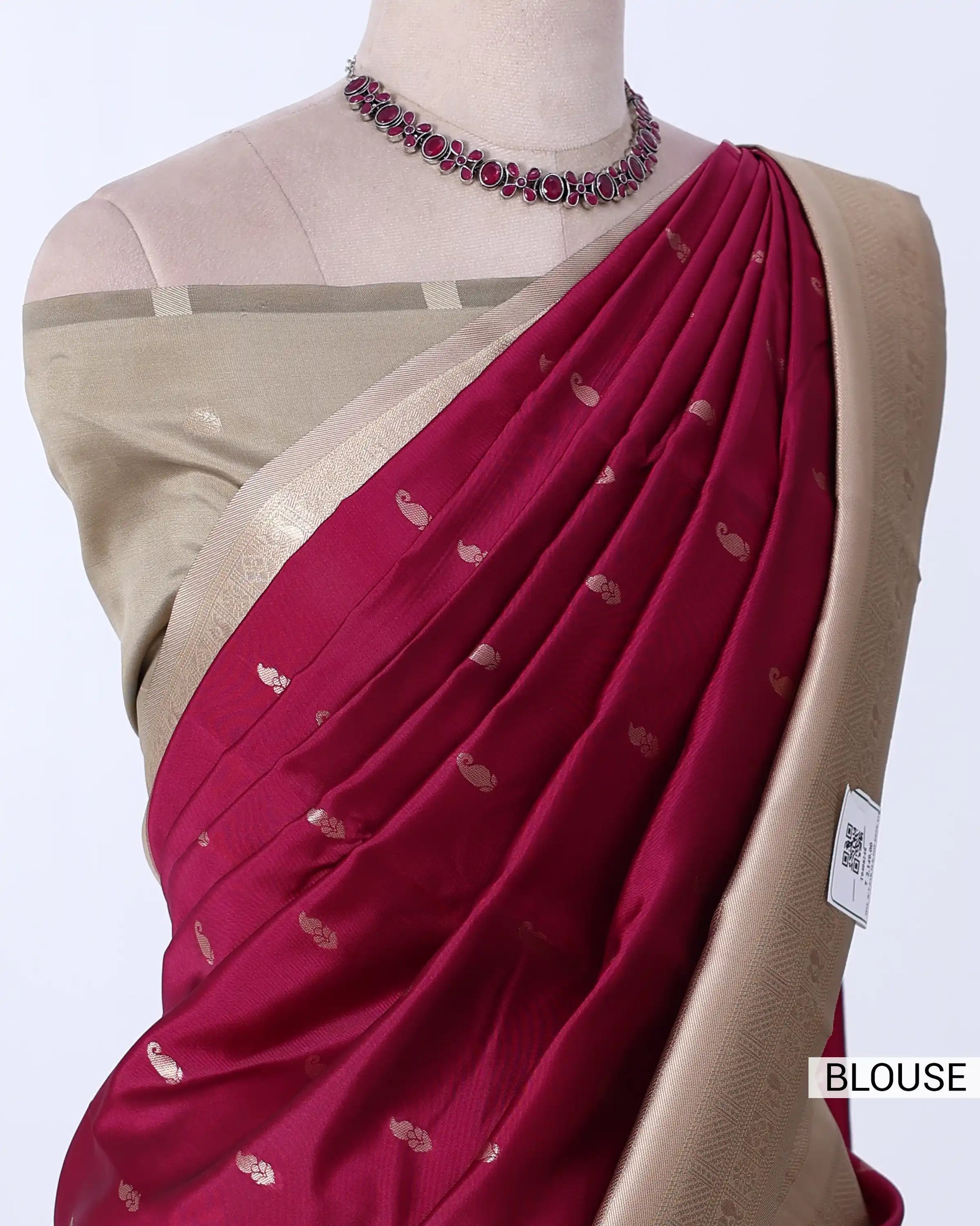 A deep magenta pink saree with small metallic gold motifs