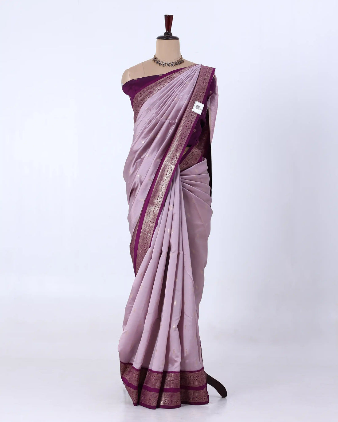 A lavender purple silk saree with a metallic gold border