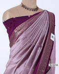 A lavender and purple silk saree with a deep purple blouse, features a pleated body, a metallic gold border, and a deep purple border 