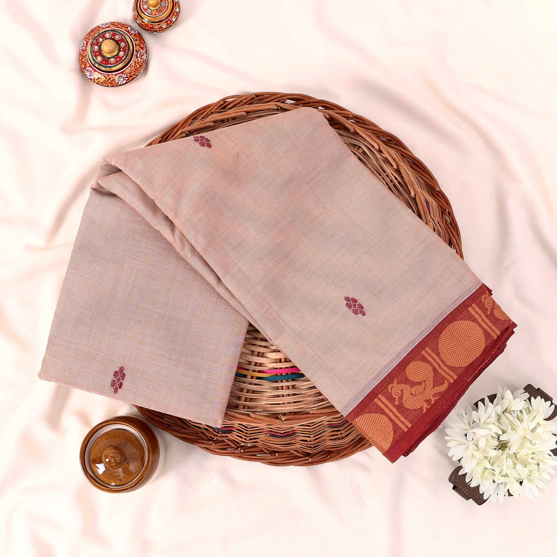 Kanchi Cotton Saree With Red Zari Border And Delicate Woven Motifs In Beige Folded Flat Lay Top View Display
