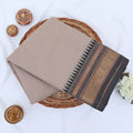 Chettinad cotton saree with plain body and temple zari woven border in beige folded top view