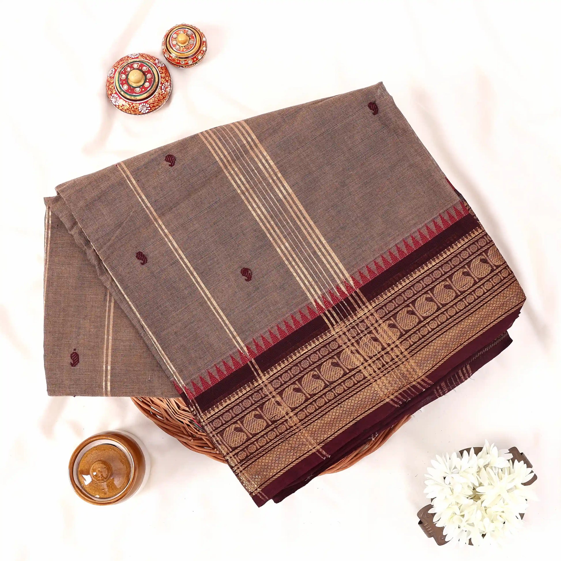 Chettinad cotton saree with zari buttas striped body and temple zari border in brown folded top view
