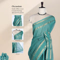 Chettinad cotton saree with elegant zari border and checked body with woven butta motifs dark green front draped view