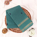 Chettinad cotton saree with checked body and zari border in dark green folded top view