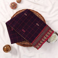 Chettinad cotton saree with checked pattern in deep purple and pink zari woven border folded flat lay front view.