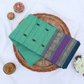 Chettinad cotton saree with mint green checked body black butta motifs and zari floral border folded flat lay view