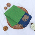 Chettinad cotton saree with elephant zari border and checked body in light green and blue folded top view.