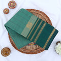 Chettinad cotton saree with sea green striped body dark green zari border and peacock motif folded flat lay view