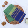 Chettinad cotton saree with sea green striped body blue zari border and peacock motif folded flat lay view