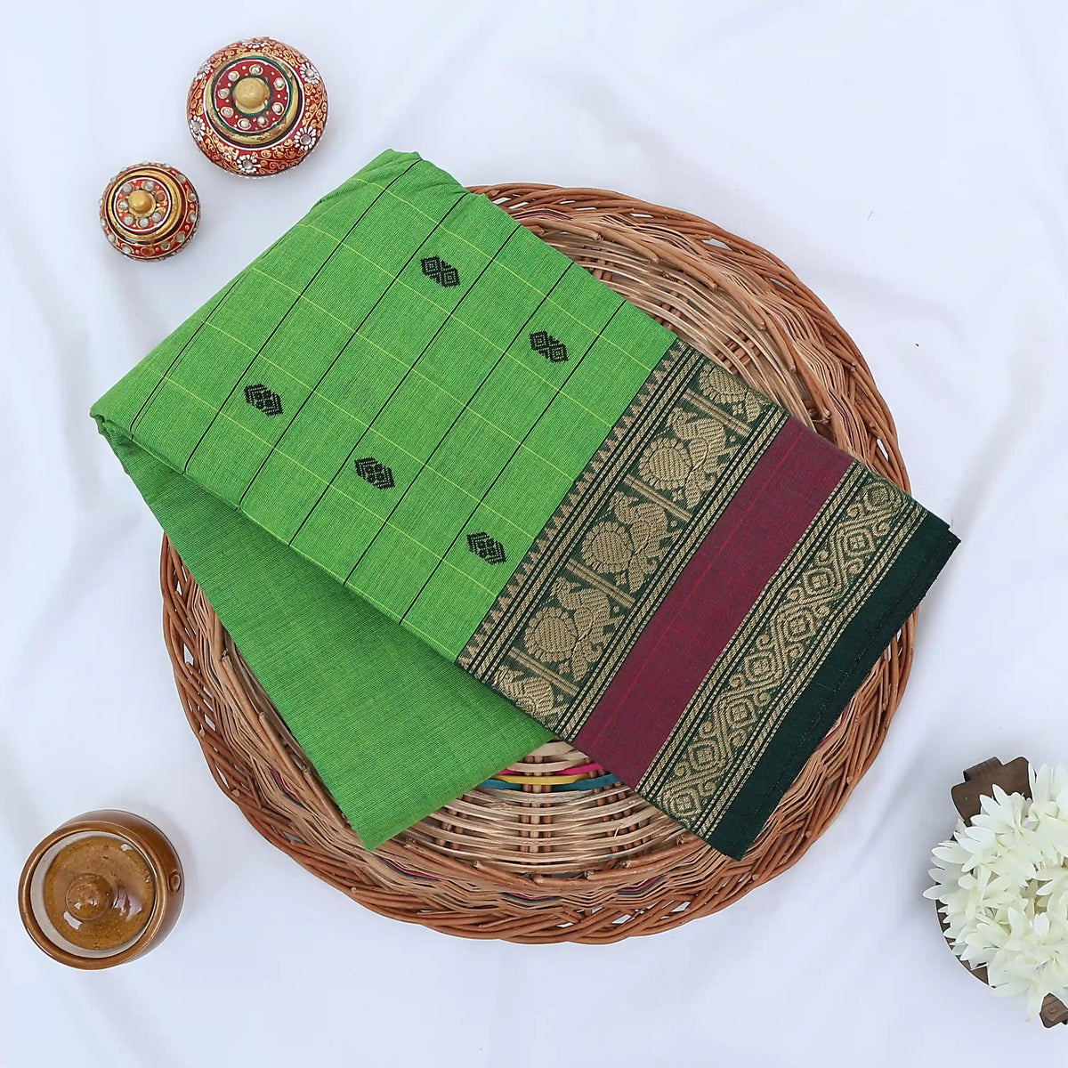 Chettinad cotton saree with zari buttas checked body peacock zari border in maroon and green folded top view
