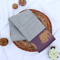 Chettinad cotton saree with gold checked pattern and elephant zari woven border in grey flat lay view