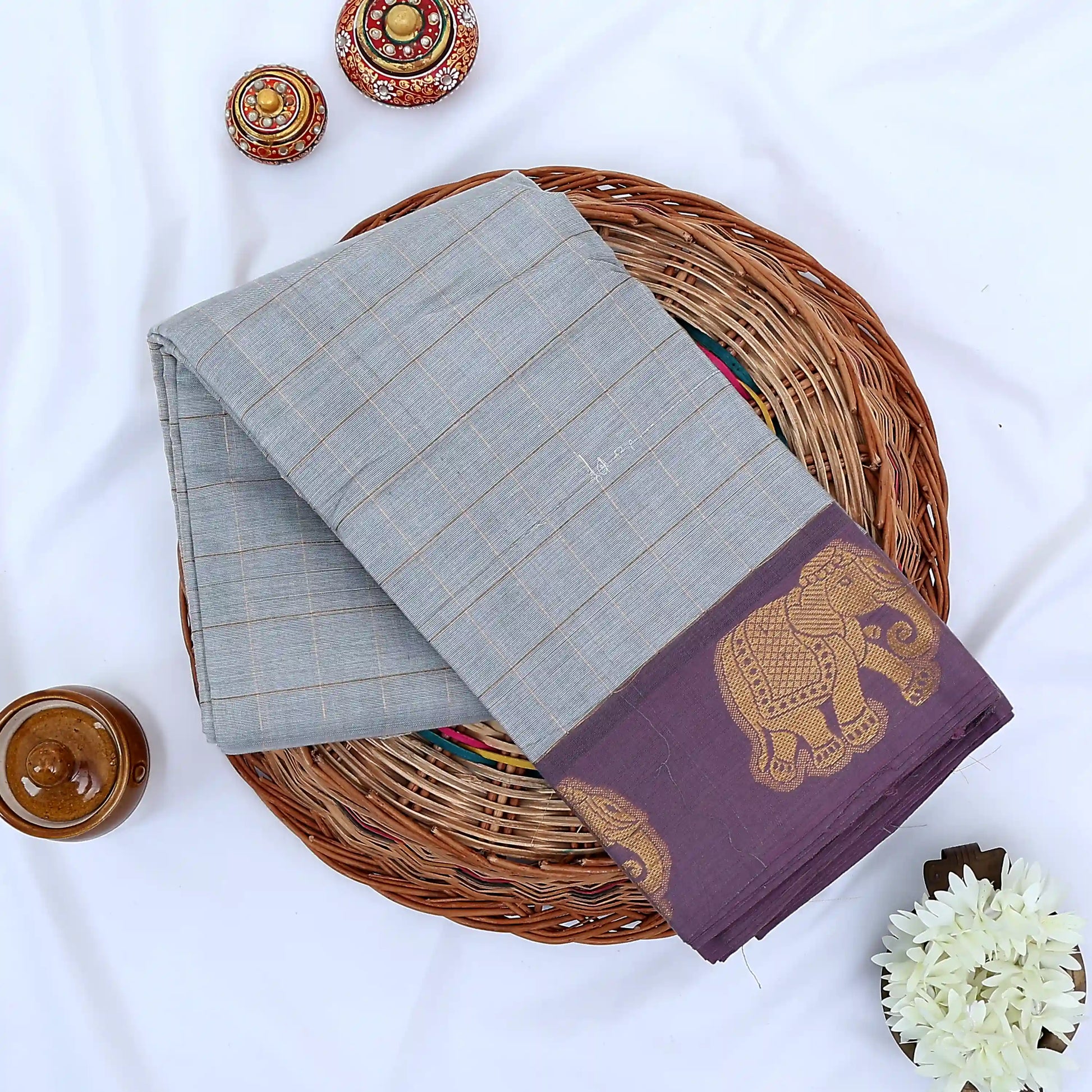 Chettinad cotton saree with gold checked pattern and elephant zari woven border in grey flat lay view