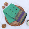 Chettinad cotton saree with zari buttas checked body peacock zari border in purple and green folded top view