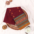 Chettinad cotton saree with zari floral butta striped body peacock border in maroon folded top view