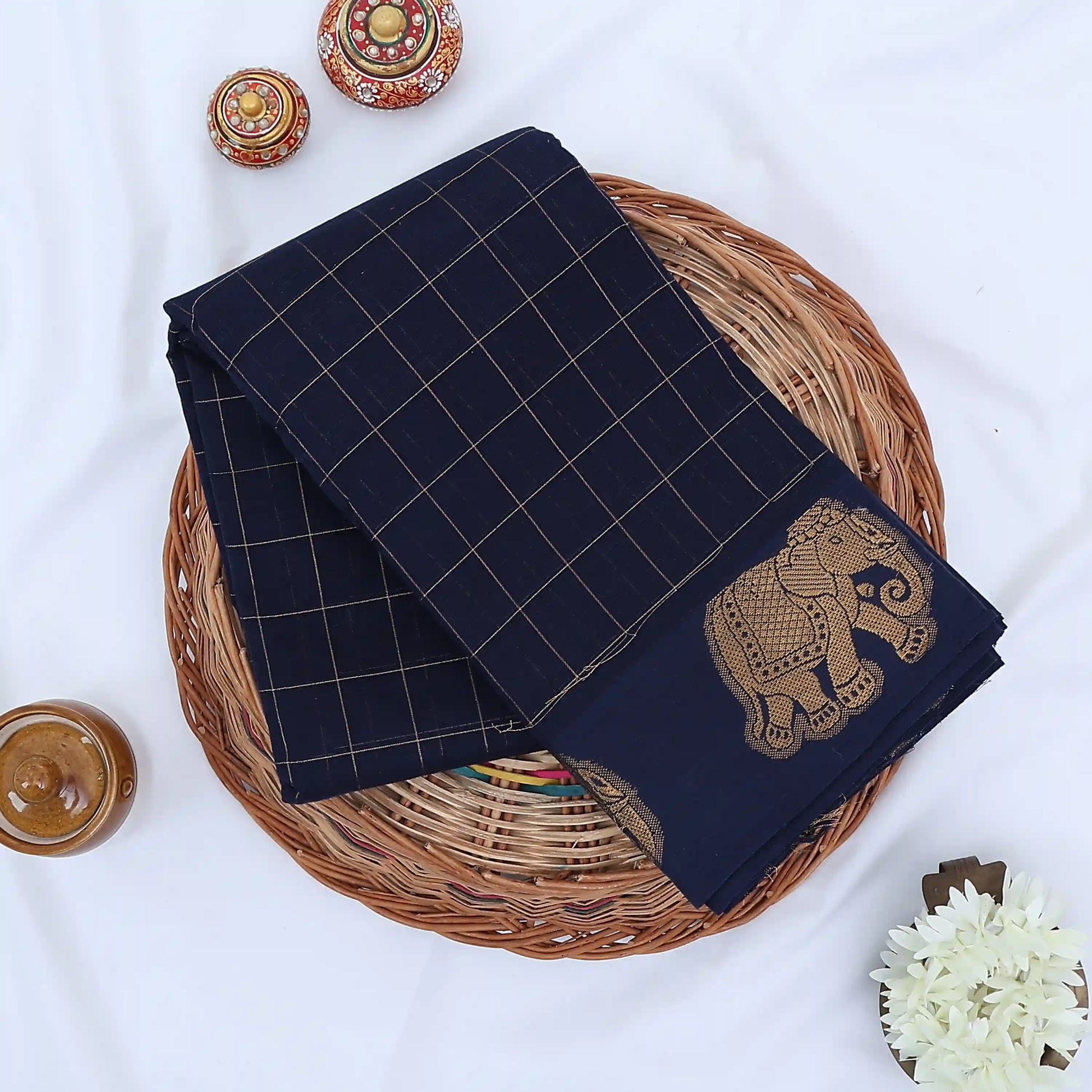 Chettinad cotton saree with gold checked pattern and elephant zari woven border in navy blue flat lay view