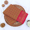Chettinad cotton saree with olive checked body pink peacock zari border and butta motifs folded flat lay view