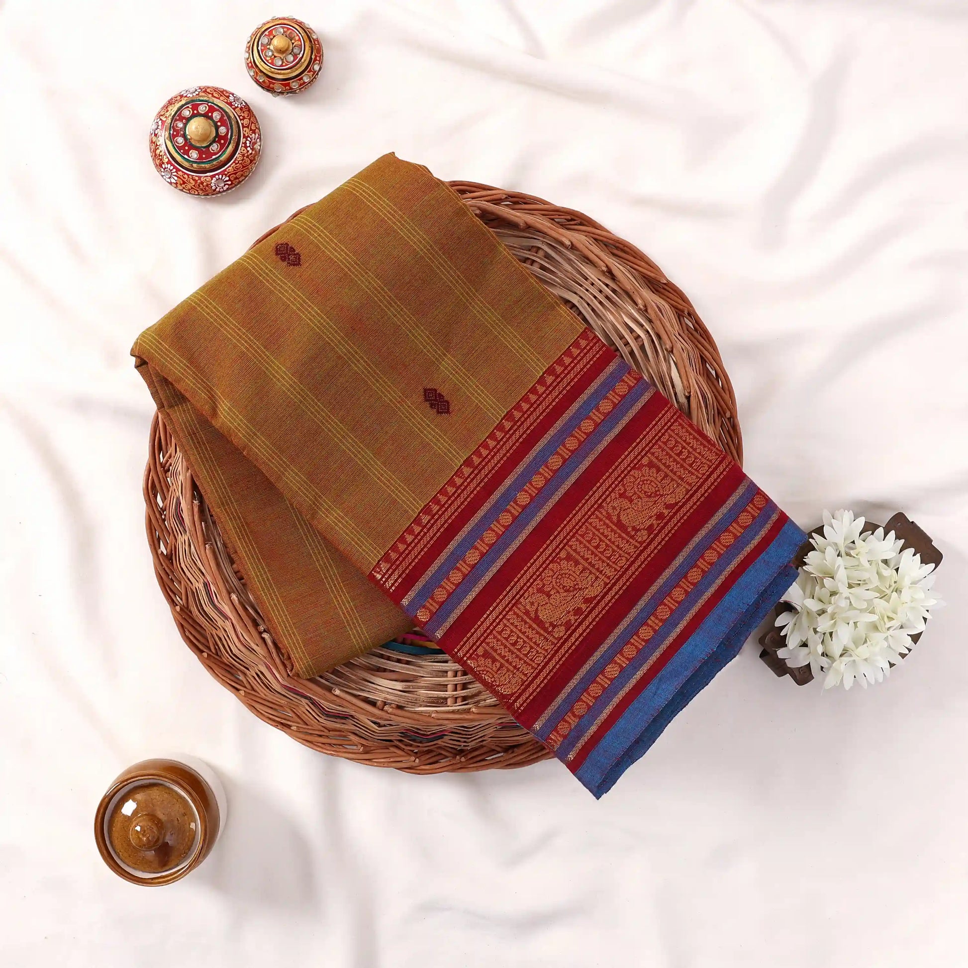 Chettinad cotton saree with zari buttas and temple zari border in olive green and blue folded top view