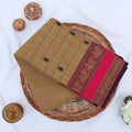 Chettinad cotton saree with zari buttas checked body peacock zari border in olive and pink folded top view