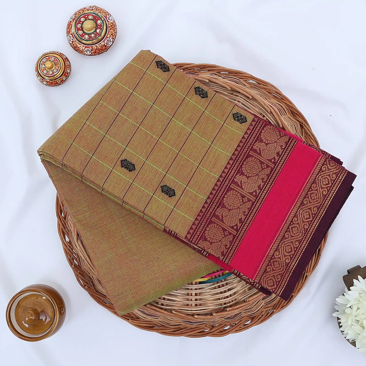 Chettinad cotton saree with zari buttas checked body peacock zari border in olive and pink folded top view