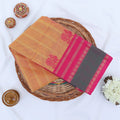 Chettinad cotton saree with striped pattern in orange contrast green and pink zari border folded flat lay front view.