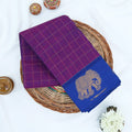Chettinad cotton saree with elephant zari border and checked body in purple and blue folded top view.