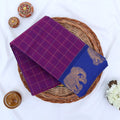 Chettinad cotton saree with elephant zari border and checked body in purple and blue folded top view.