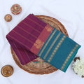 Chettinad cotton saree with purple striped body teal zari border and peacock motifs folded flat lay view