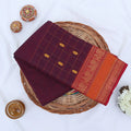 Chettinad cotton saree with zari buttas checked body peacock zari border in purple and orange folded top view