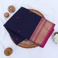 Chettinad cotton saree with zari border in navy blue and magenta folded top view with woven motifs
