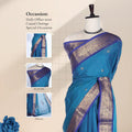Chettinad cotton saree with broad floral zari border teal plain body with subtle buttas front draped view on mannequin.