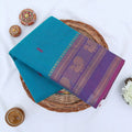 Chettinad cotton saree with peacock buttas and peacock zari woven border in teal green folded top view
