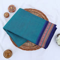 Chettinad cotton saree with plain body and temple border in teal and blue folded top view