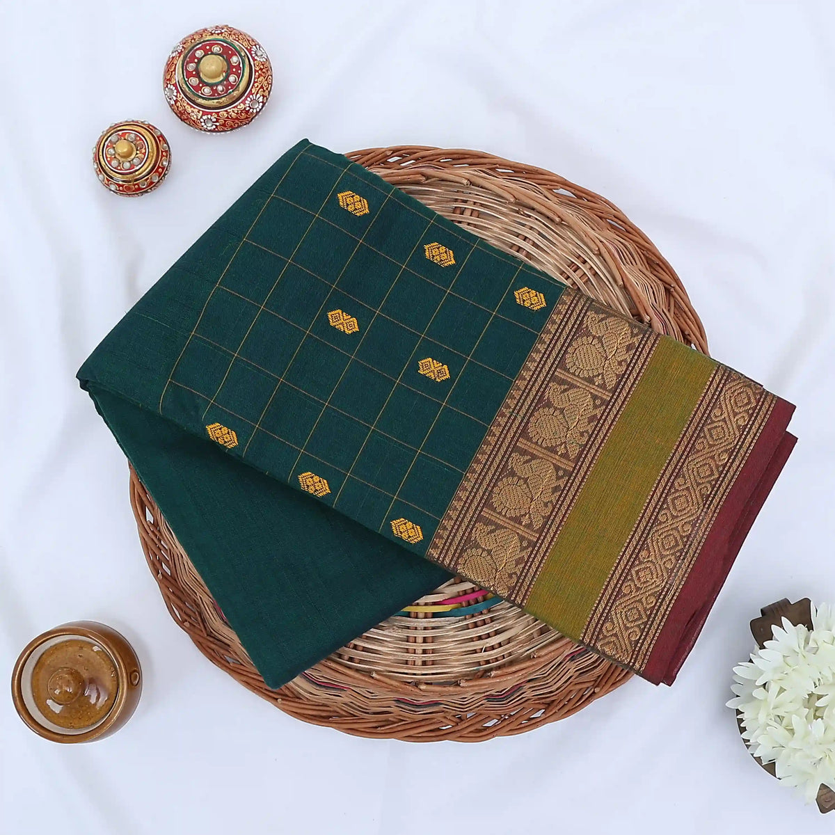 Chettinad cotton saree with zari buttas checked body peacock zari border in teal and green folded top view