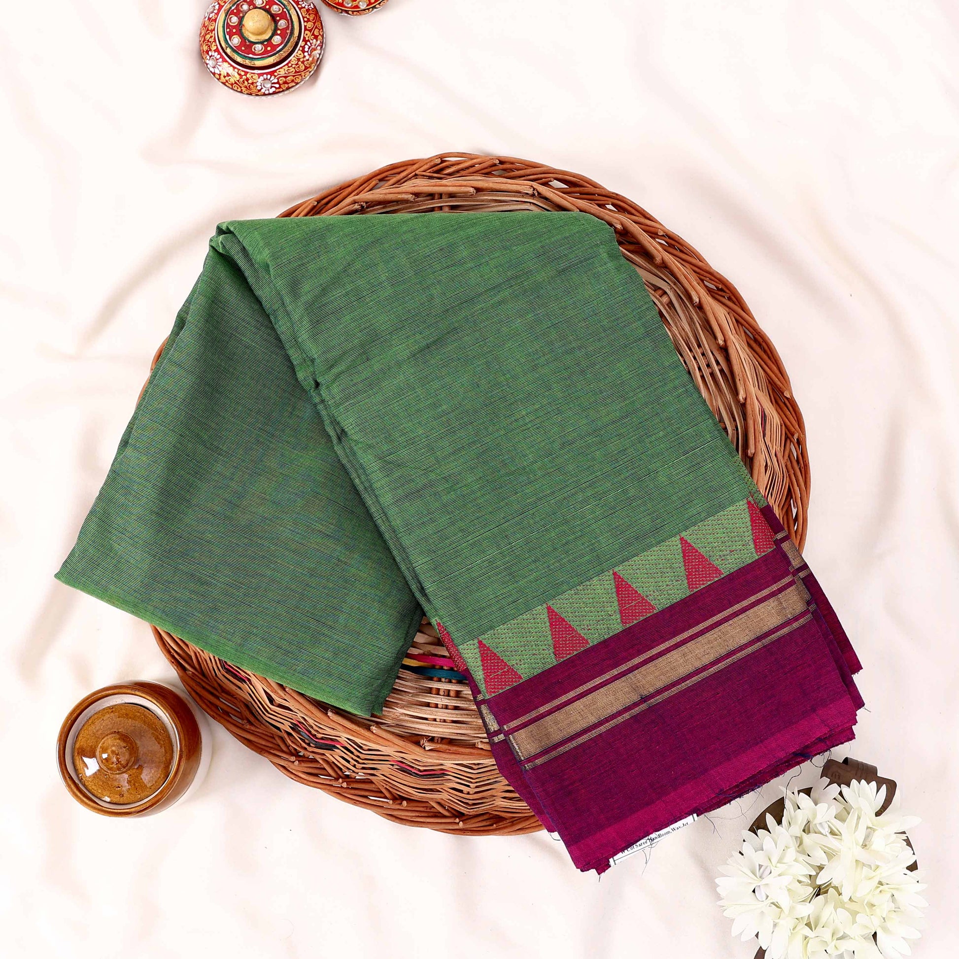 Green Kanchi Cotton Saree With Magenta And Gold Temple Border Folded Display Top View Flat Lay
