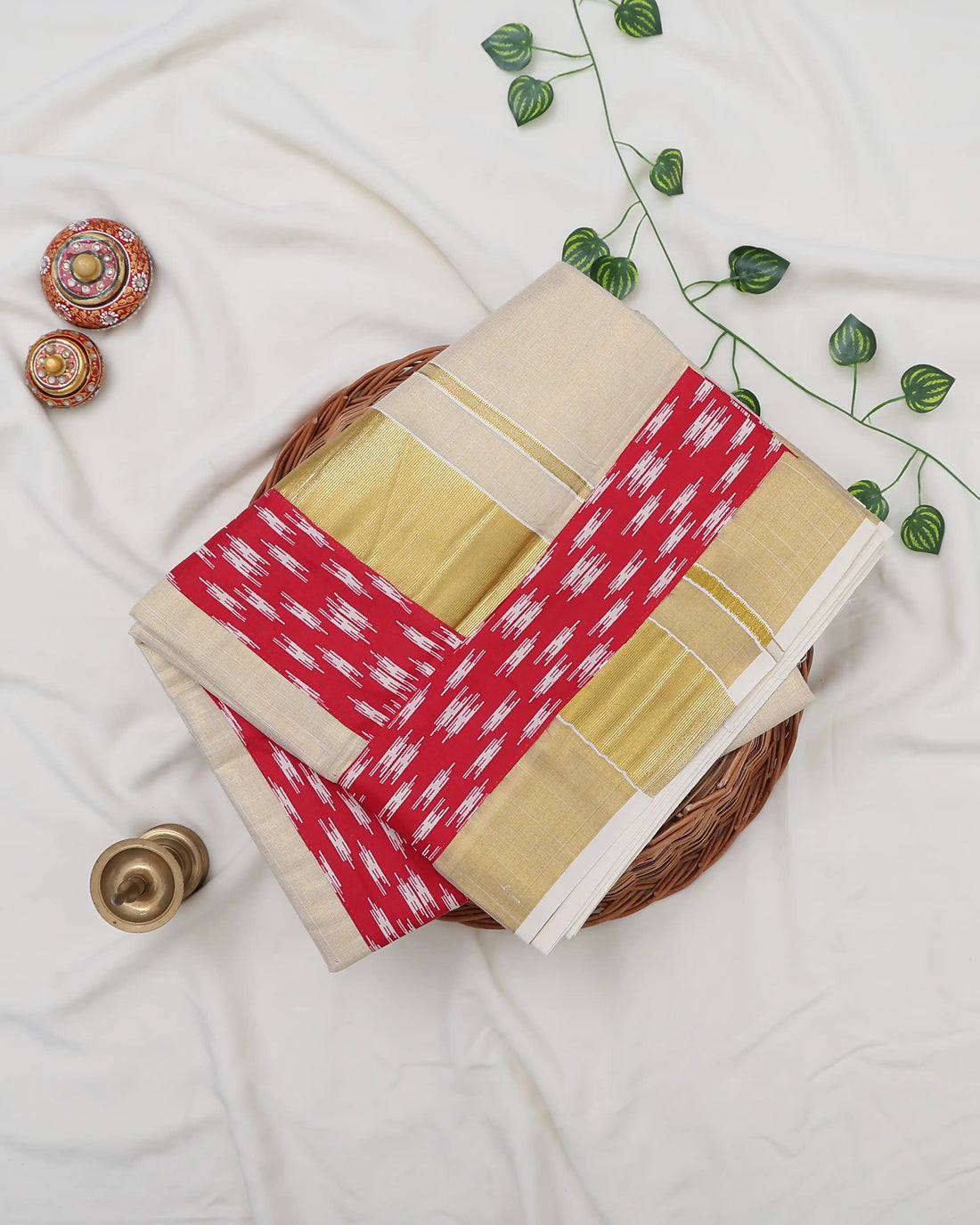 A cream-colored kerala saree with a red and white patterned border and matching blouse - full view