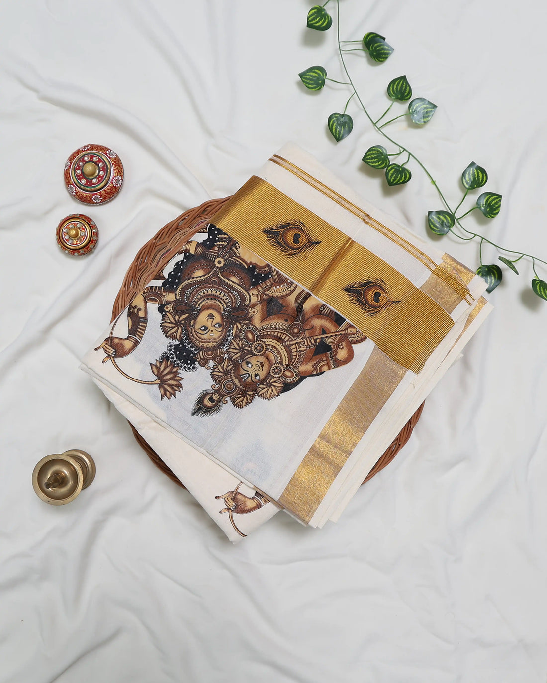 An off-white saree with gold zari borders and brown printed motifs full view
