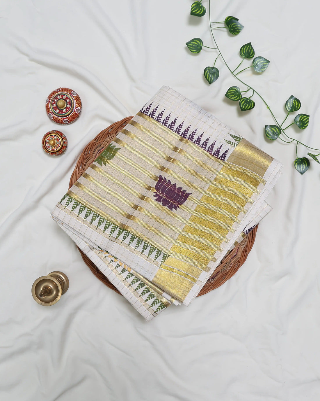 An off-white kerala saree with gold zari borders and small multicolor floral motifs - full view