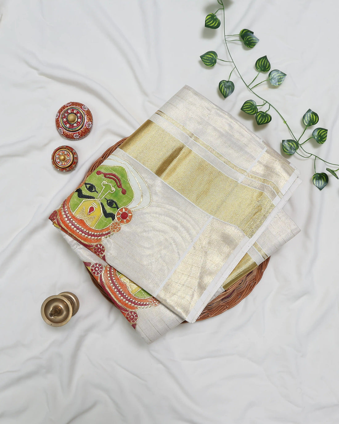 A cream-colored kerala saree with subtle stripes and colorful traditional prints on the border full view