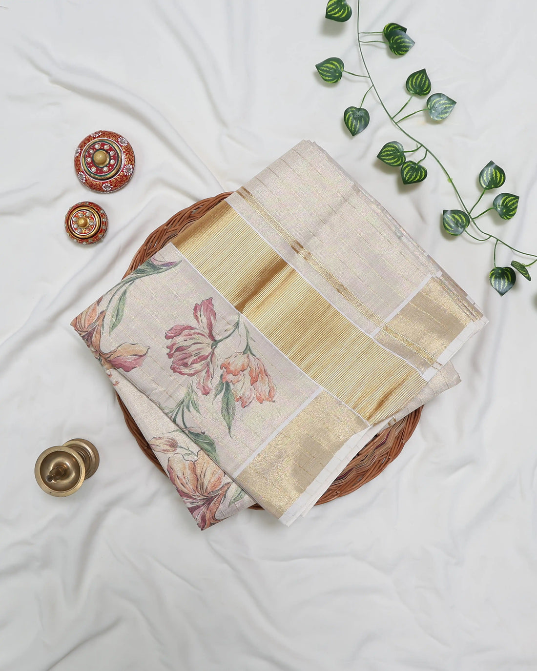 A cream-colored kerala saree with delicate floral prints and a gold border - full view