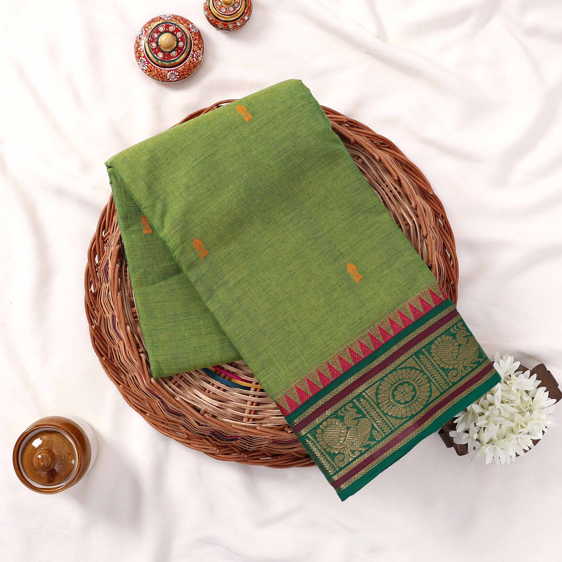 Kanchi Cotton Saree With Zari Woven Border In Light Green Folded Display With Motifs Top View Flat Lay Arrangement
