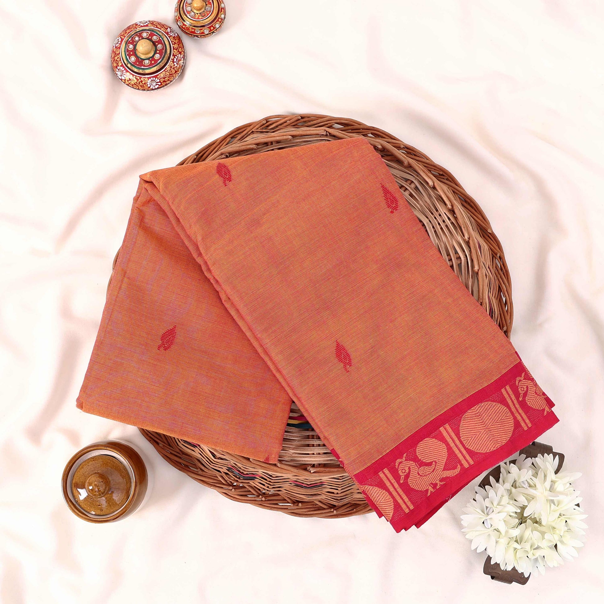 Kanchi Cotton Saree With Peacock Motif Border In Orange Color Folded Display Top View
